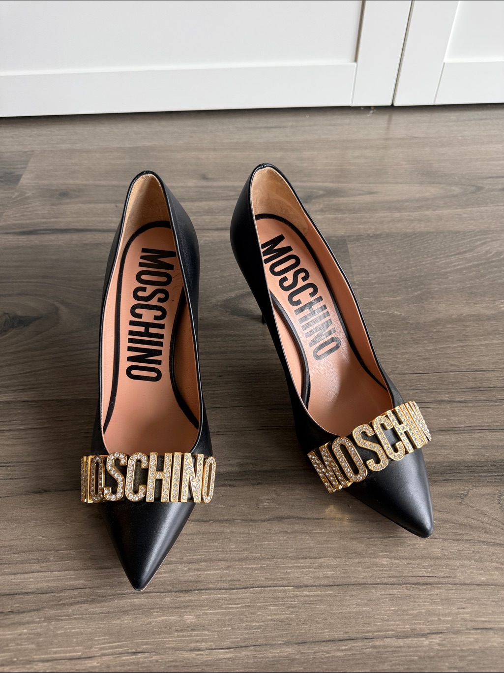 Moschino Black Pointed Leather Pumps With Gold Logo Plaque